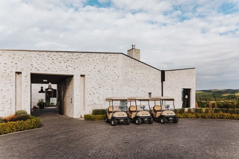 Image of golf carts in front of The Kinloch Club's main entrance, Taupo, New Zealand
