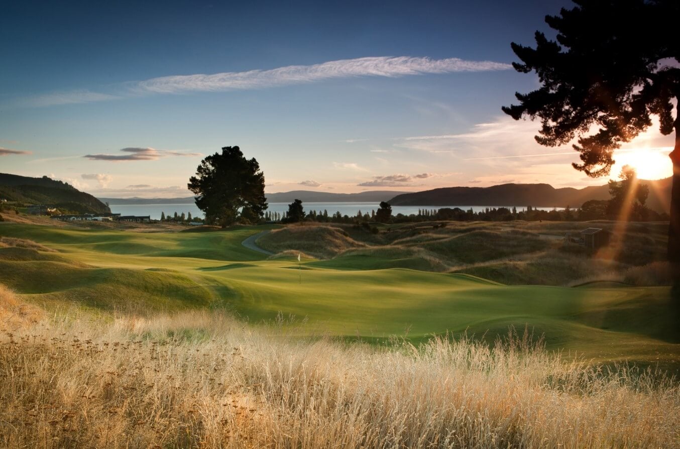 Landscape image of the Kinloch Club golf course's undulating green beneath a setting sun