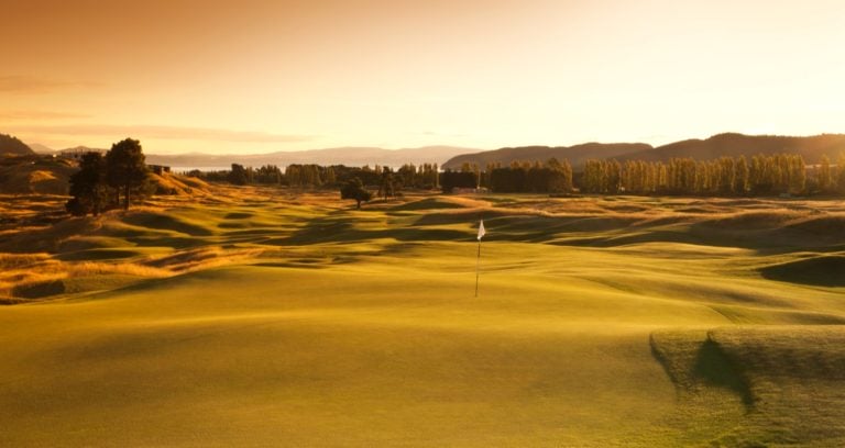 The golden light of dusk drenches The Kinloch Club's undulating golf course with light