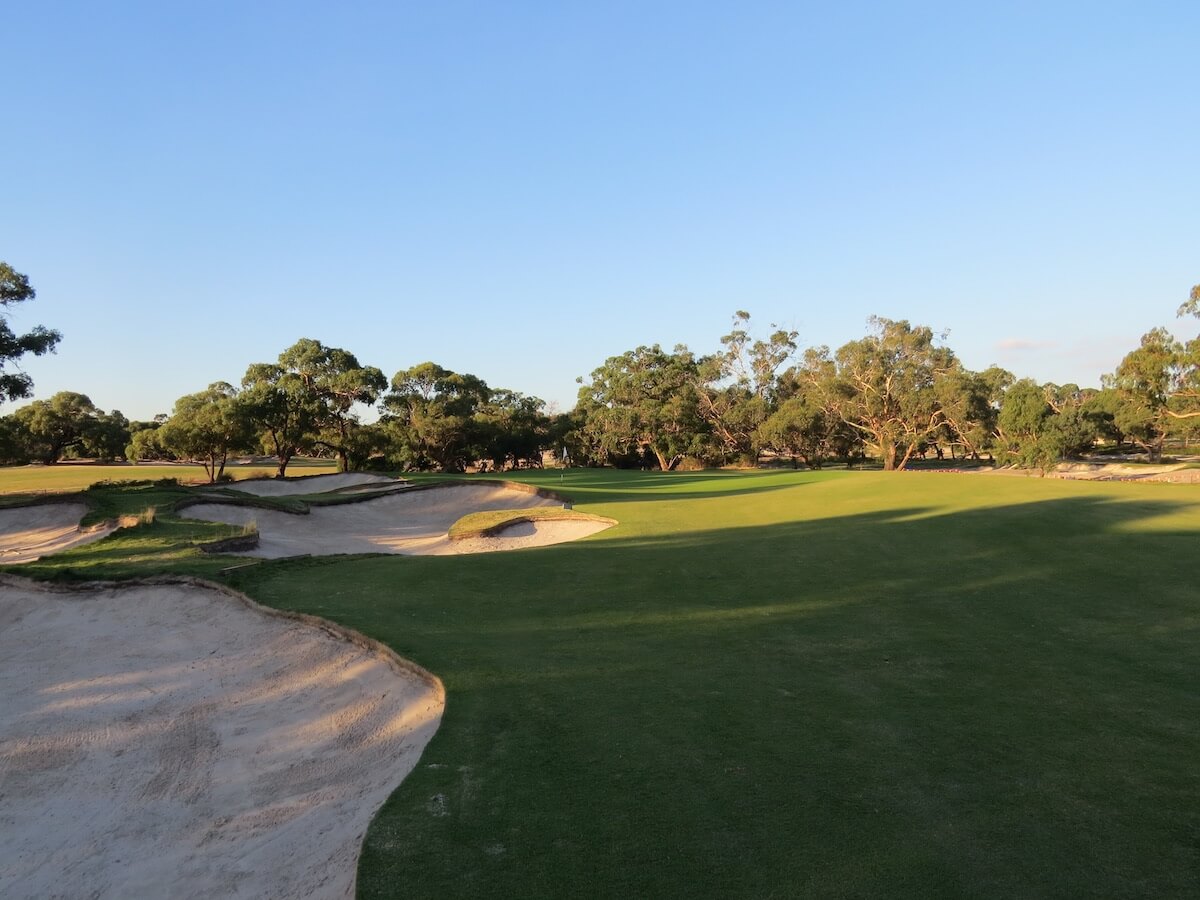 Large bunkers and trees enclose the third golf hole at Peninsula Kingswood South Course