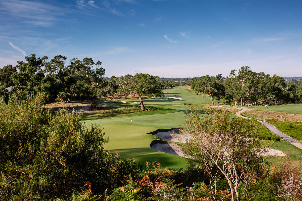 Aerial view of a green looking back down a fairway at Peninsula Kingswood South Course