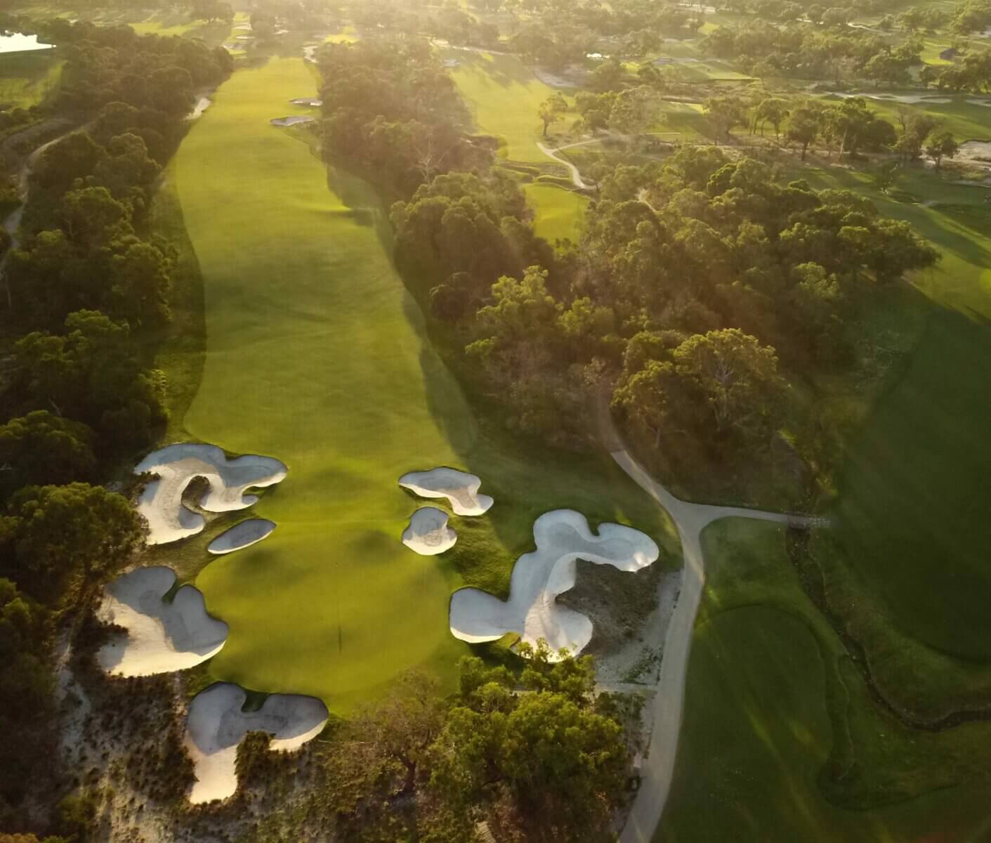 Dusk casts the south course's eighth green in golden light at Peninsula Kingswood