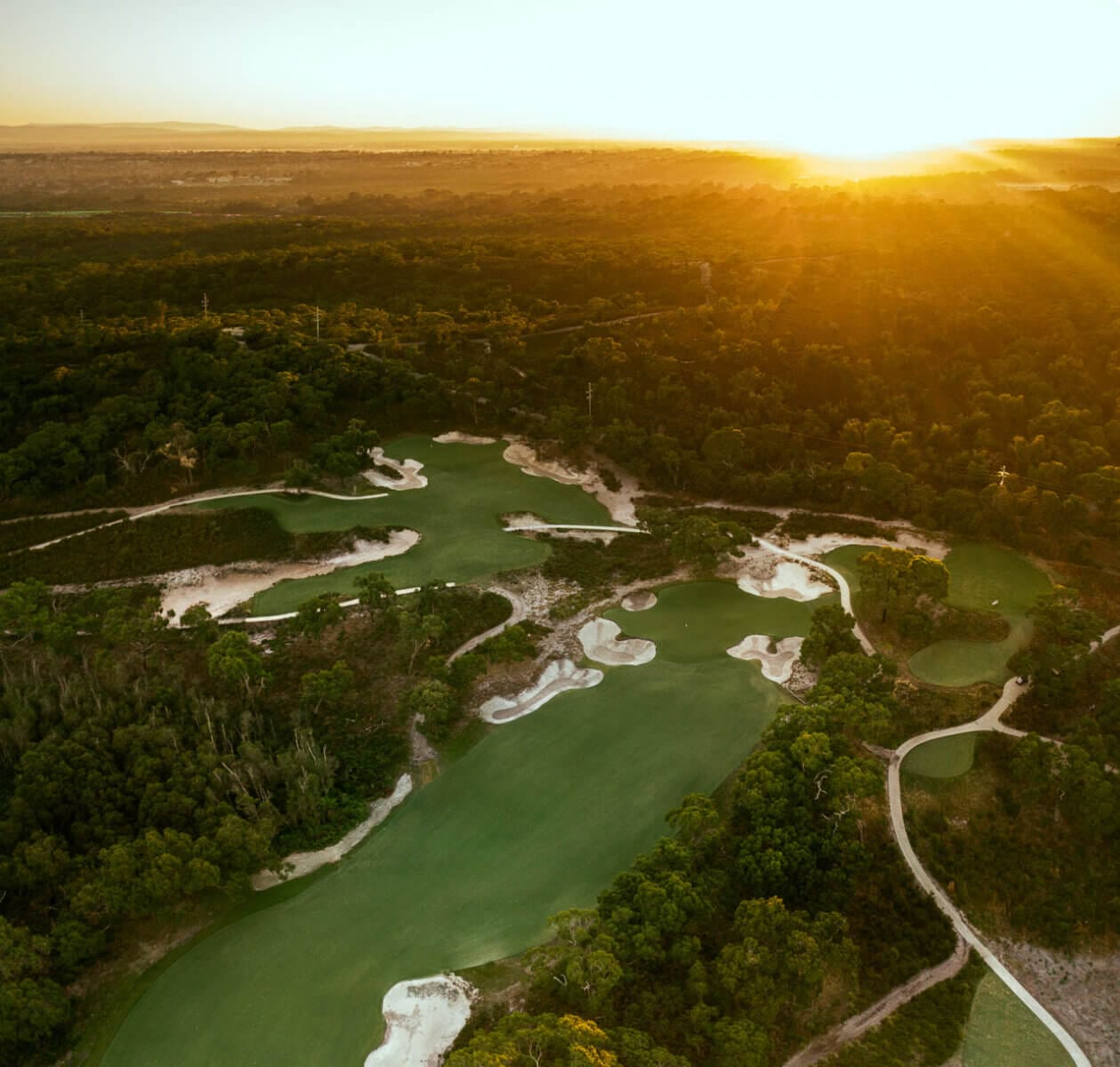 The golden sunligh of dusk settles over the Peninsula Kingswood North Course
