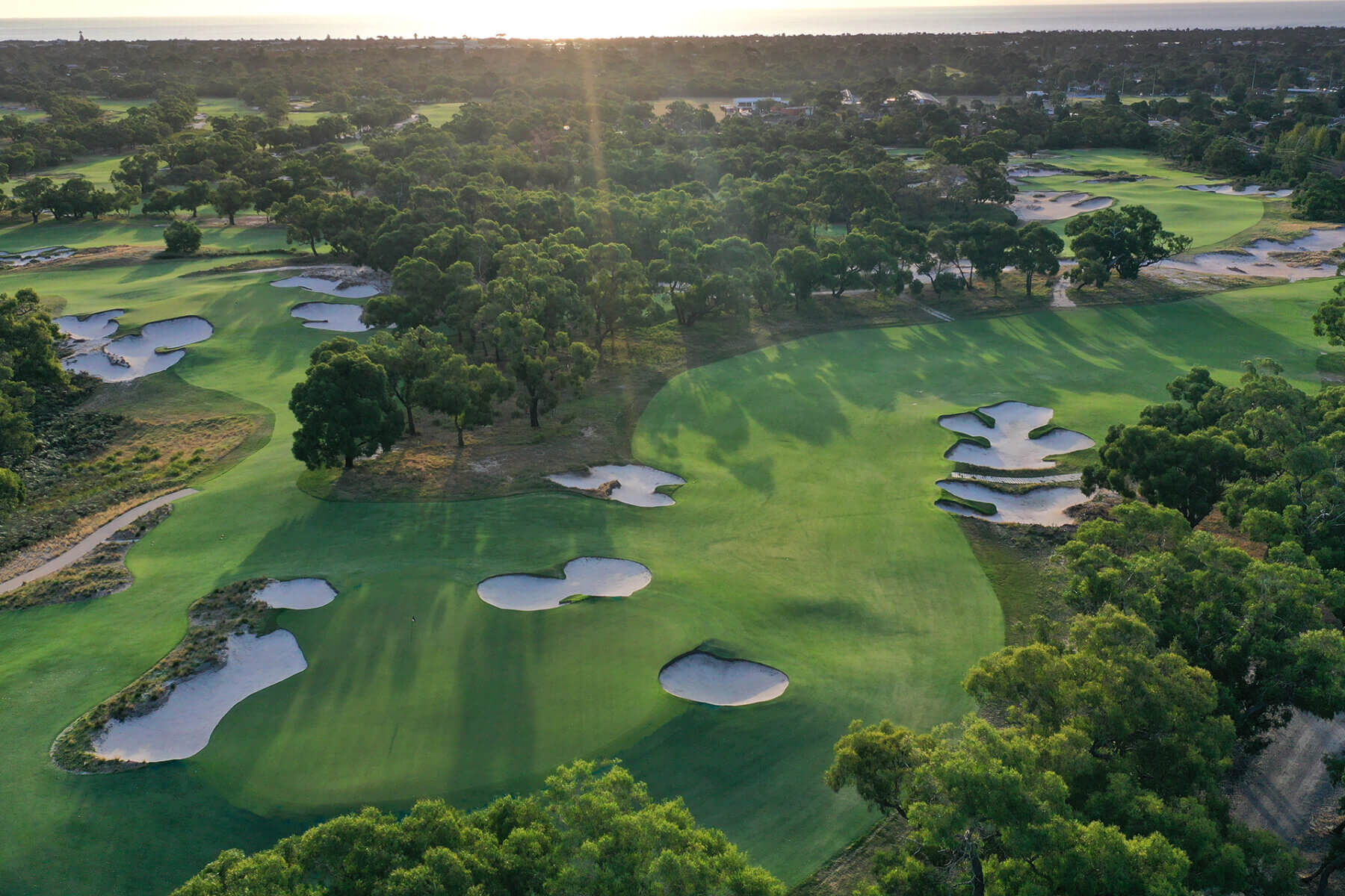 Tree-lined fairways contrast with large sandy bunkers at Peninsula Kingswood North Course