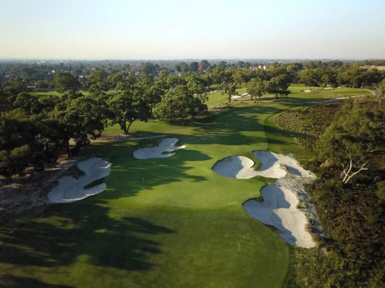Aerial view of the seventh green with large sandy bunkers surrounding