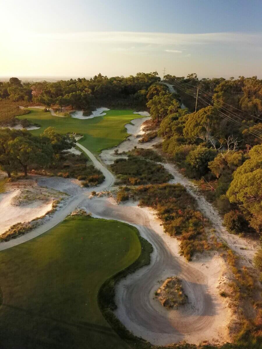 Aerial view of the second hole fairway separated by hazardous sand and foliage