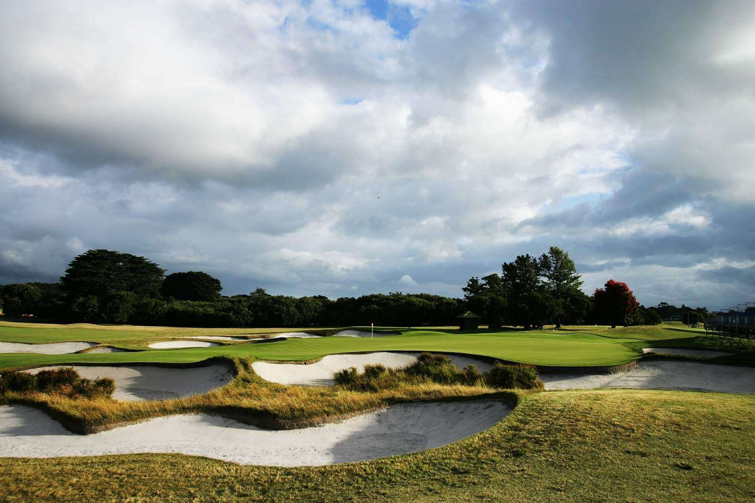 A green is flanked by two large bunkers at Royal Melbourne