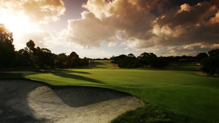Sunlight casts golden light over the second green at Royal Melbourne East Course