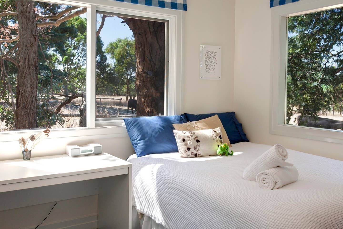 Blue and white themed bedroom overlooking paddocks at Merricks North Retreat