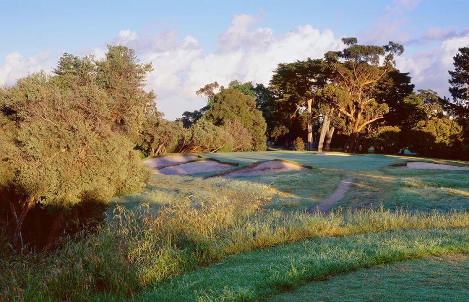 Dense foliage and scrub surround the ninth green at Long Island Golf Club