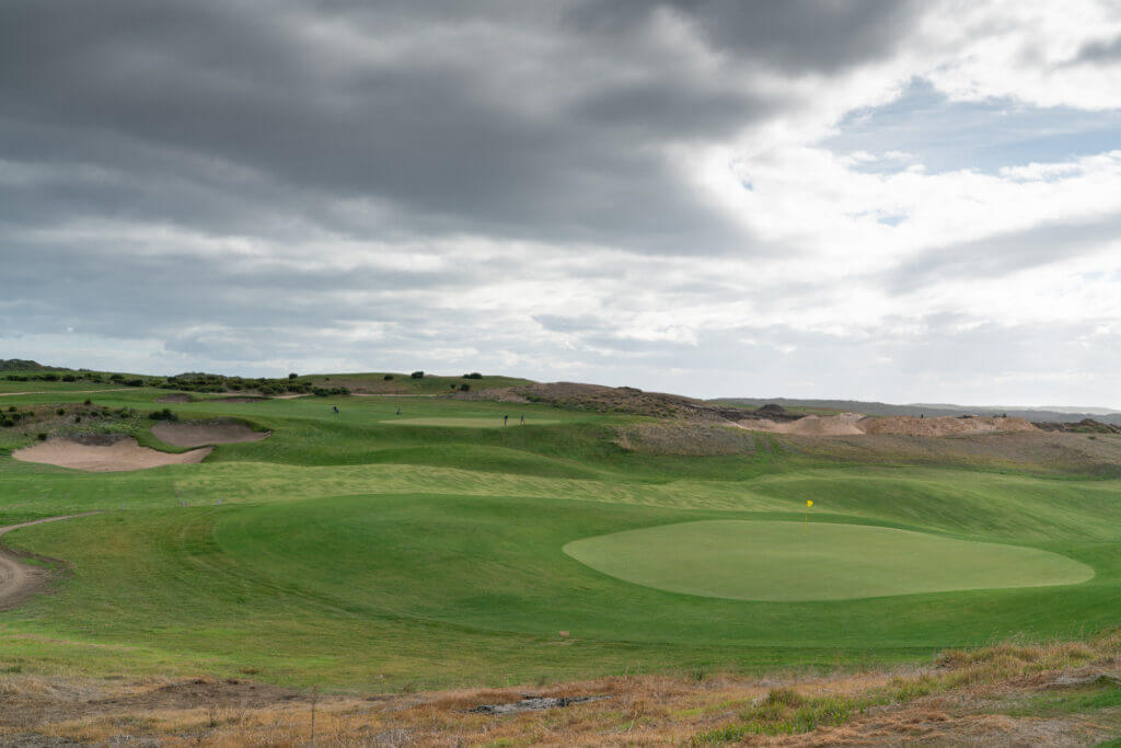 Landscape view of a large green surrounded by manicured grass