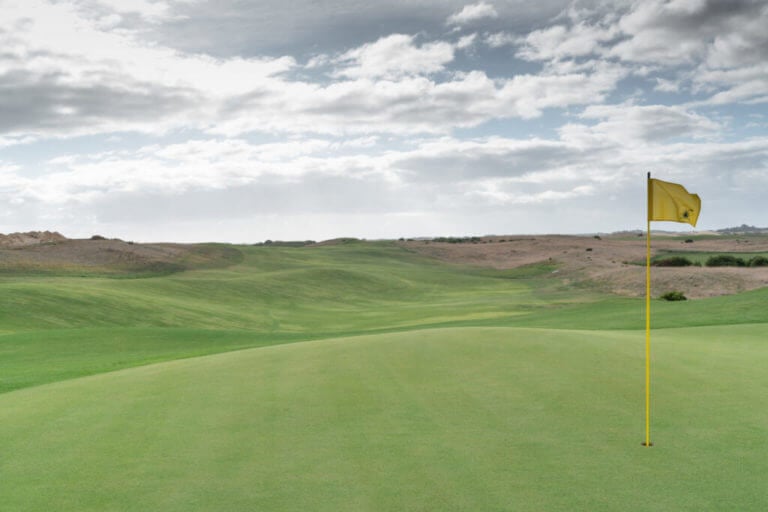 Wide fairways lead to a valley separating an uphill green on the thirteenth hole