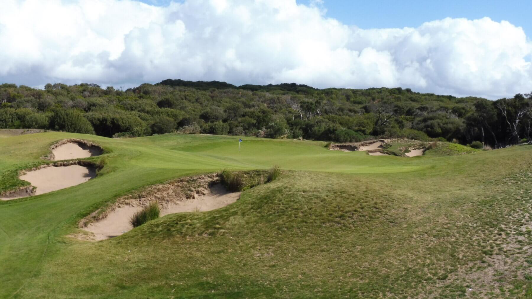 Overlooking the eleventh green surrounded by sand bunkers and hills
