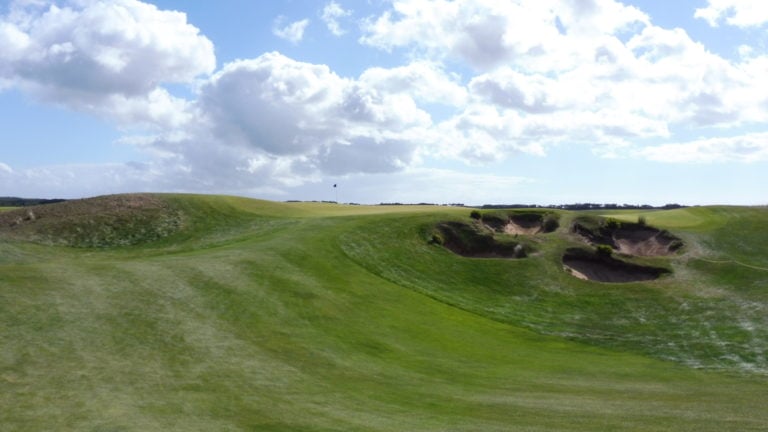 Four strategic bunkers protect a raised eighth green on The Naitonal's Moonah Course