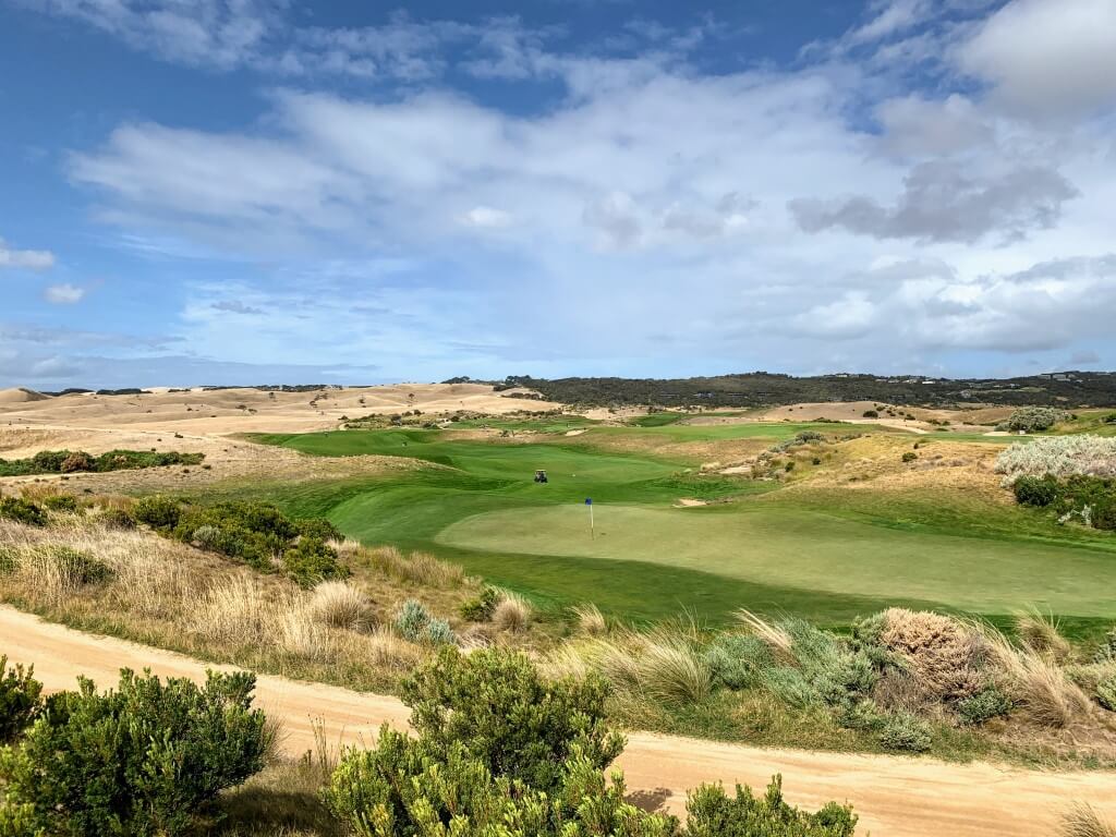 Overlooking a green and golf cart on the National's Moonah Course