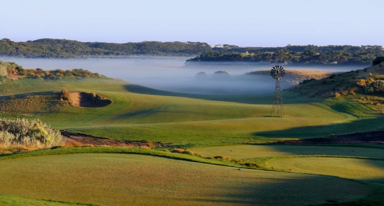 An iconic windmill features on the tenth hole in front of a misty valley