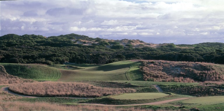 Wide open fairway contrasts with dense seaside scrub on The Moonah course