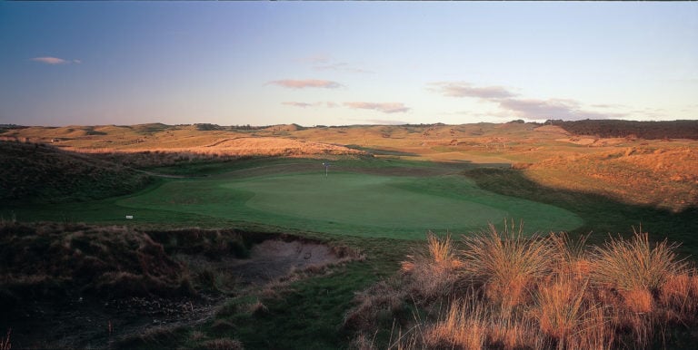 A view of the large seventh green shrouded in shadow on the Moonah Course