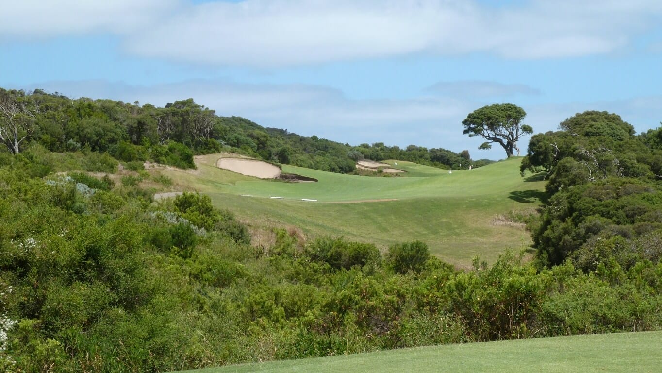 A ravine filled with scrub separates the first tee from the fairway