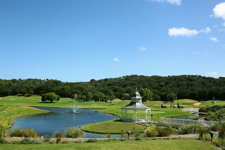 A gazebo stands next to a lake with fountain at Eagle Ridge Golf Club