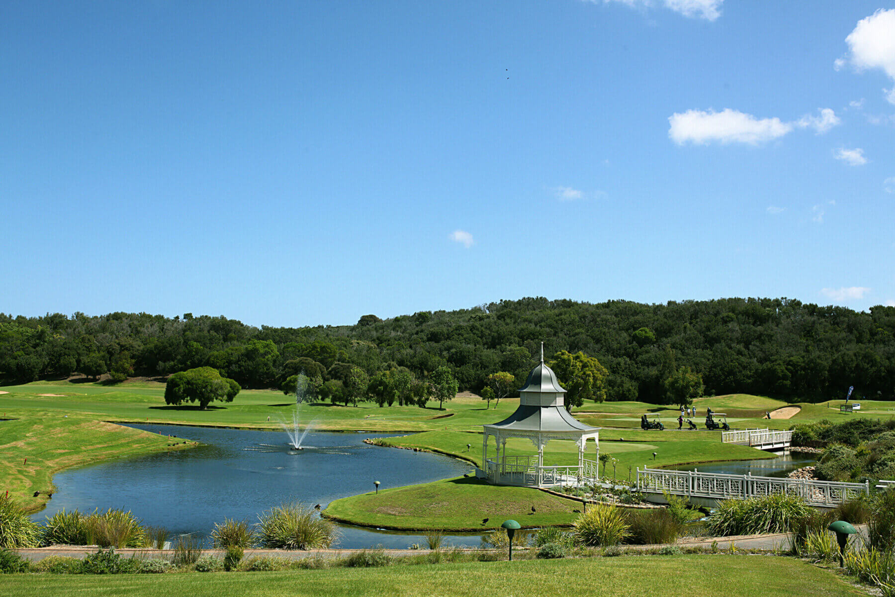 A gazebo stands next to a lake with fountain at Eagle Ridge Golf Club