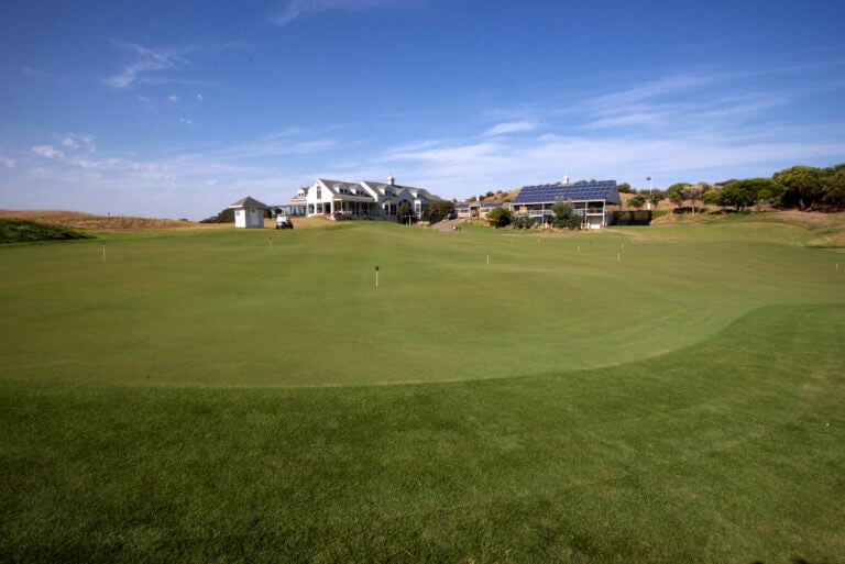 A large practice putting green sits adjacent to the clubhouse at Eagle Ridge Golf Club