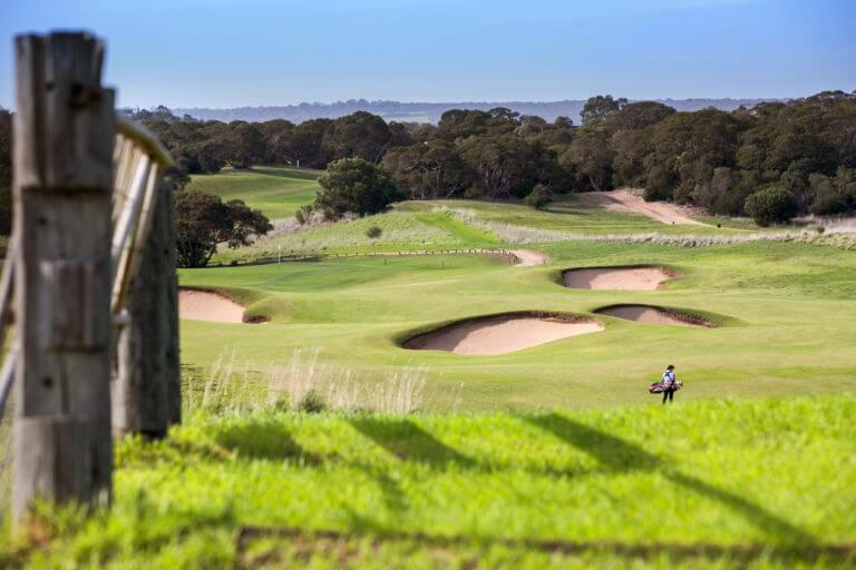 A lone golfer walks on The Open golf course at Moonah Links
