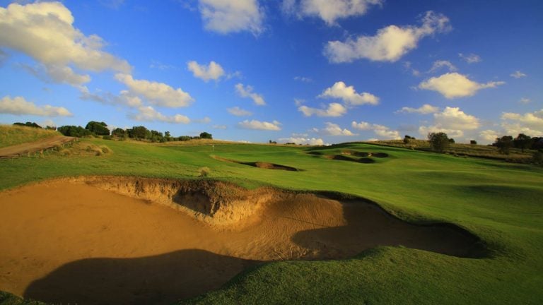 Overlooking large sand-bunkers leading to a raised green on The Open course