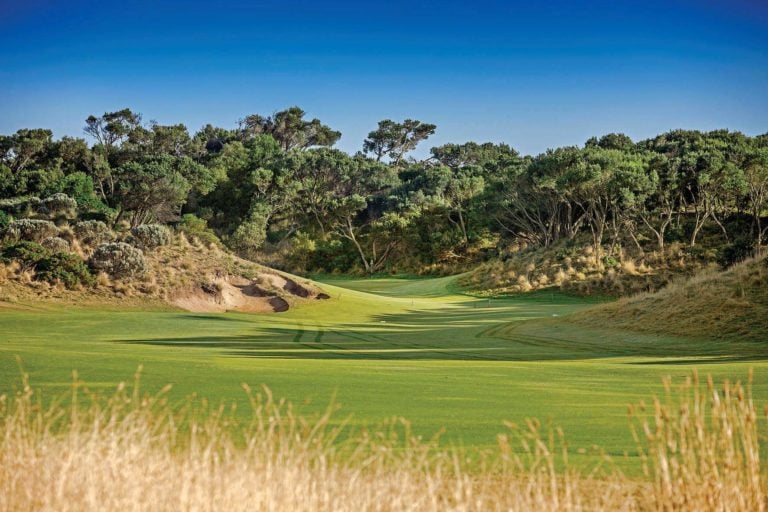 Dense moonah foliage surrounds a small green at St Andrews Beach Golf Club