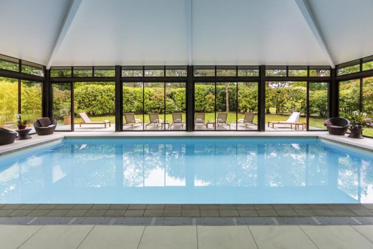 An indoor pool and lounge chairs feature at the Golf du Medoc Resort
