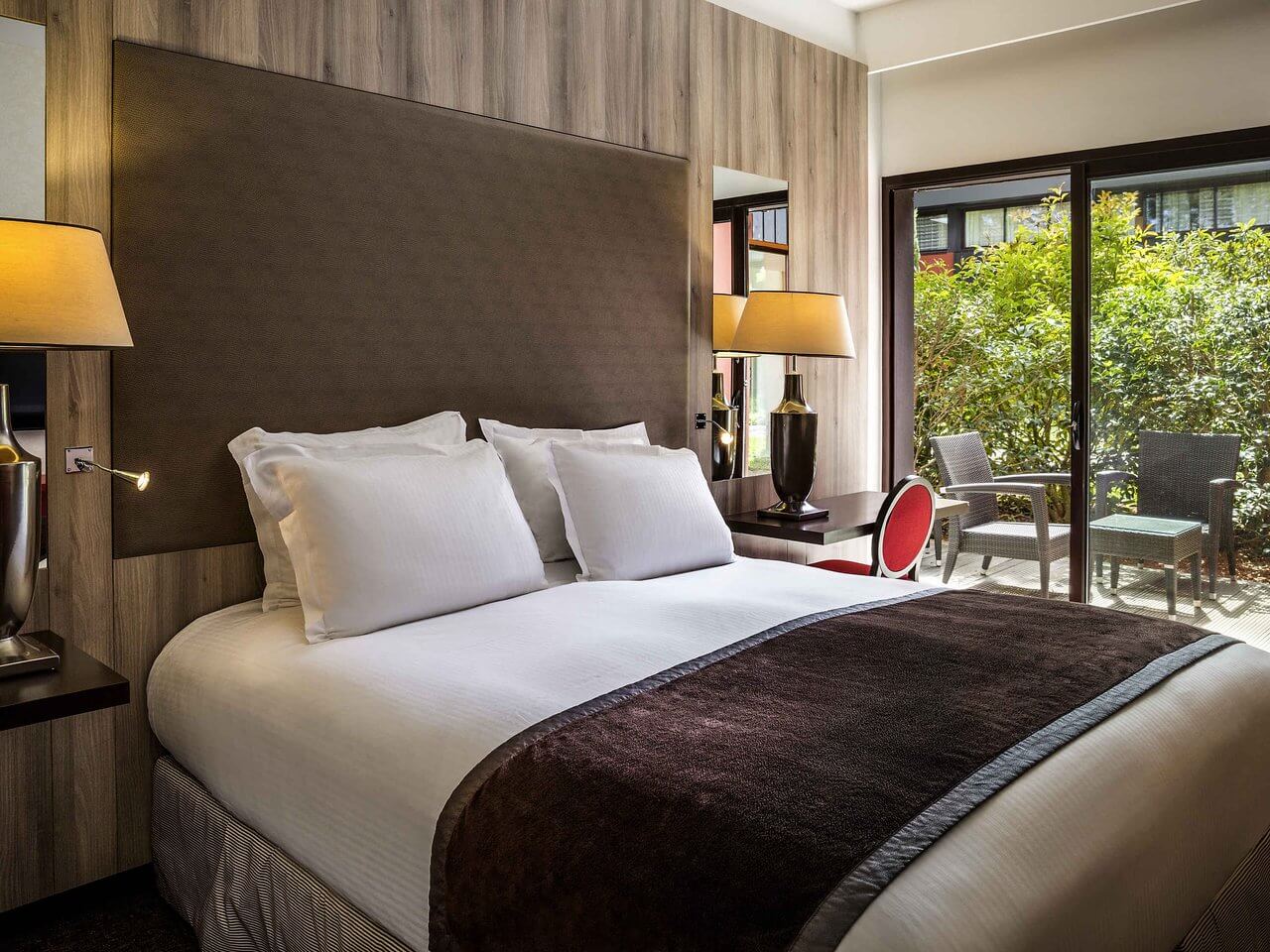 Interior view of a double bed with writing desk and private patio