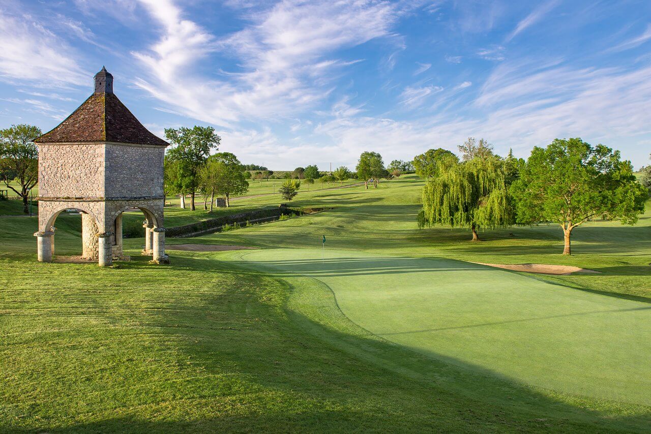 An old stone tower looms over a green at Chateaux de Vigiers golf course