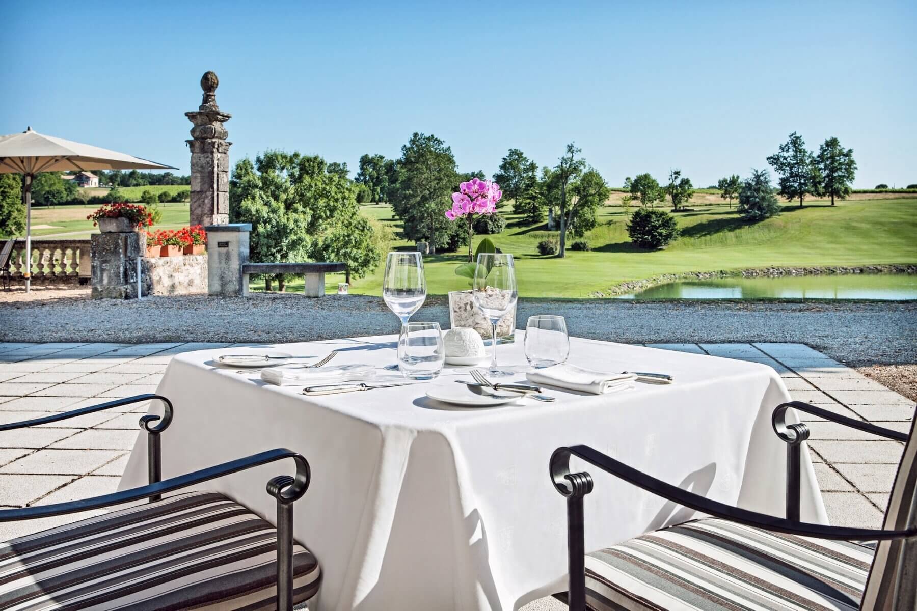 Outdoor dining on a terrace overlooks the golf course and stunning scenery