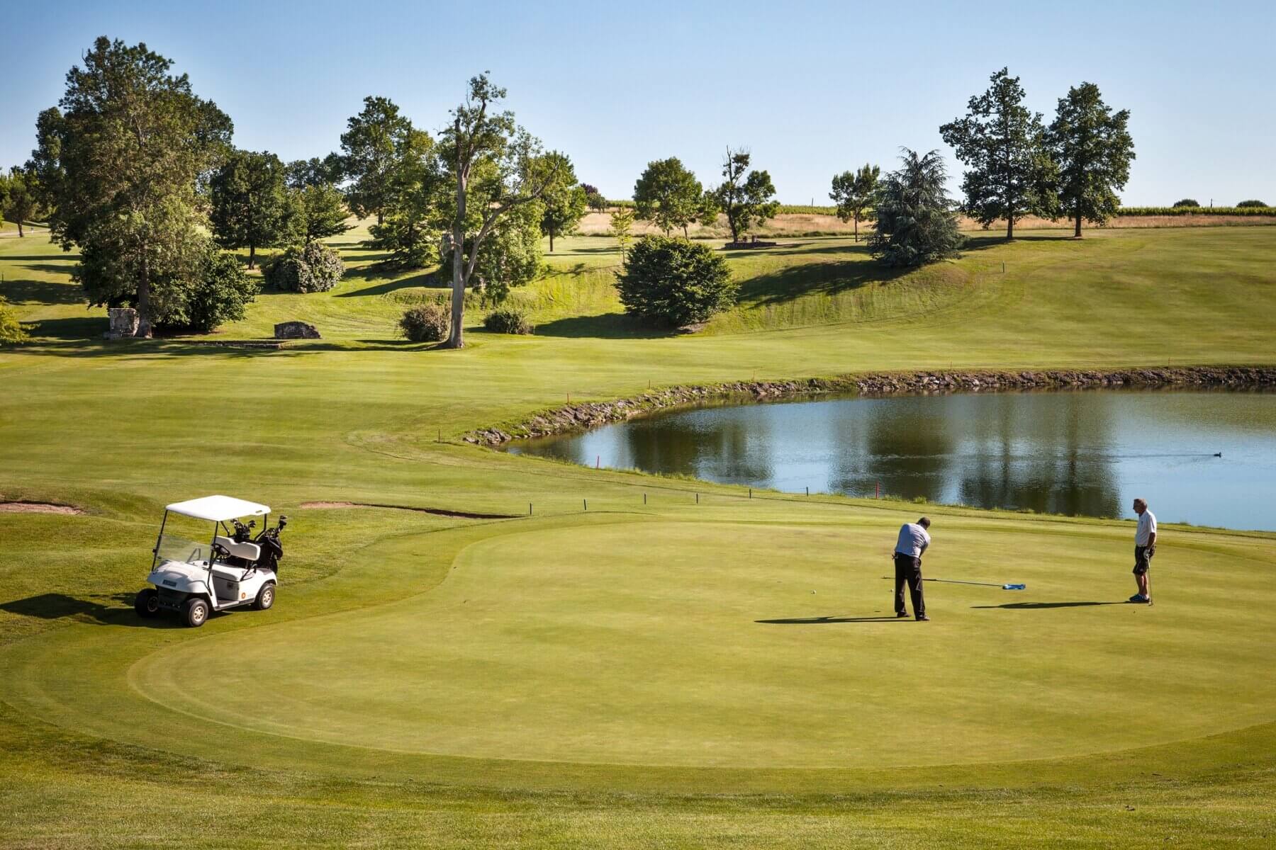 Golfers finish their round on the eighteenth green at Chateaux des Vigiers Resort