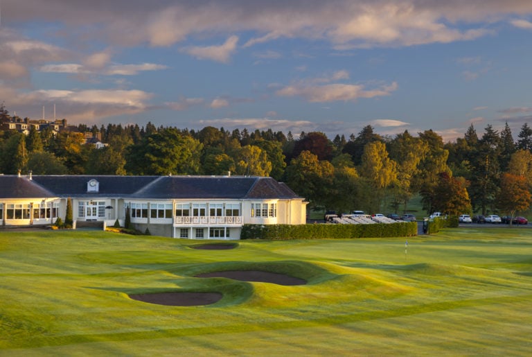 External view of the clubhouse and adjacent Queens Golf Course