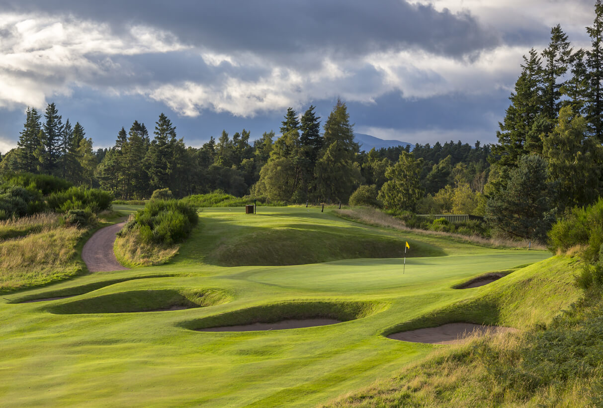A green is protected by pot bunkers on all sides