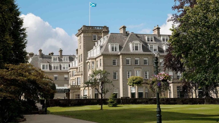 Exterior view of the Gleneagles Hotel and Scottish Flag