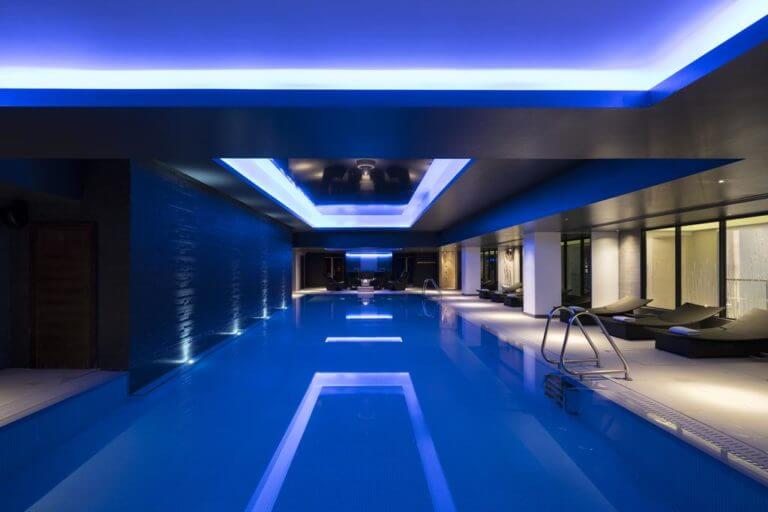 Dark blue lighting showcases the indoor pool at Gleneagles