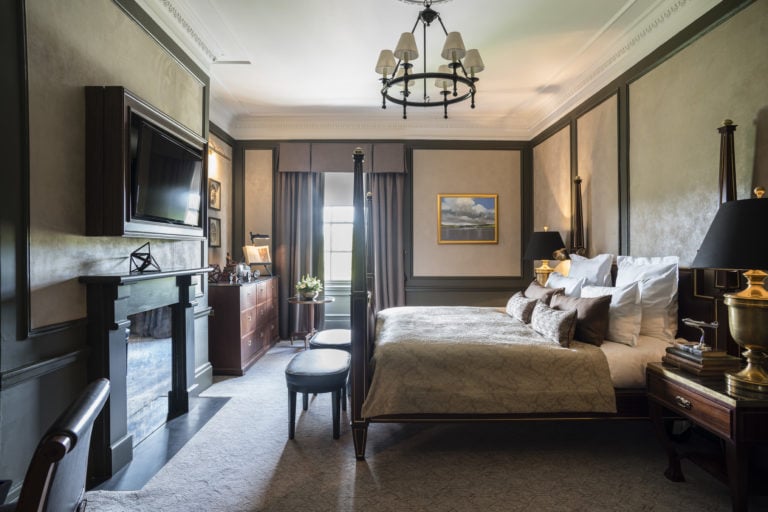 A four-poster bed and contemporary furniture adorn a bedroom at Gleneagles Resort