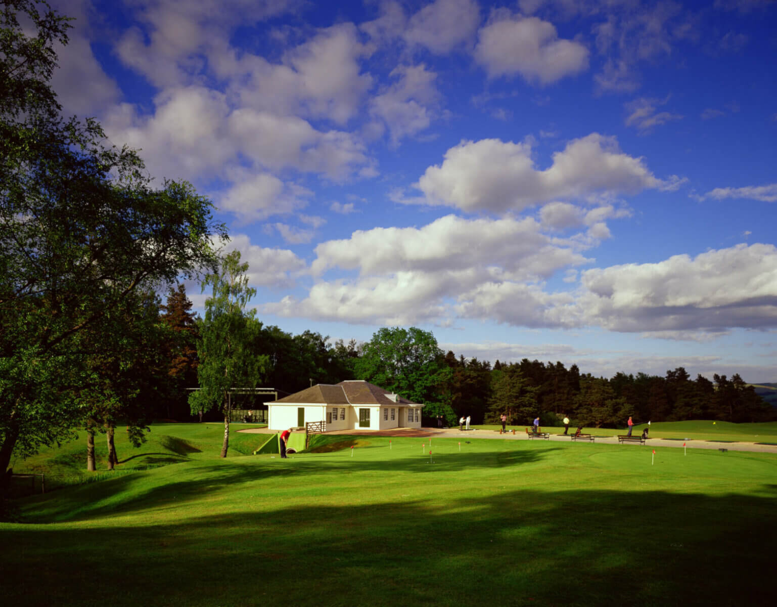 Golfers practice putting and golf shots at the PGA National Academy