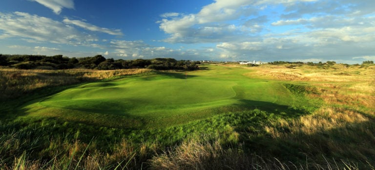 A large raised green is surrounded by long fescue grass at Royal Birkdale