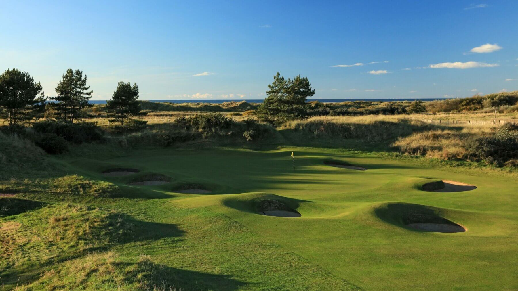 Overlooking the manicured fifth green surrounded by pot bunkers and hilly tussocks