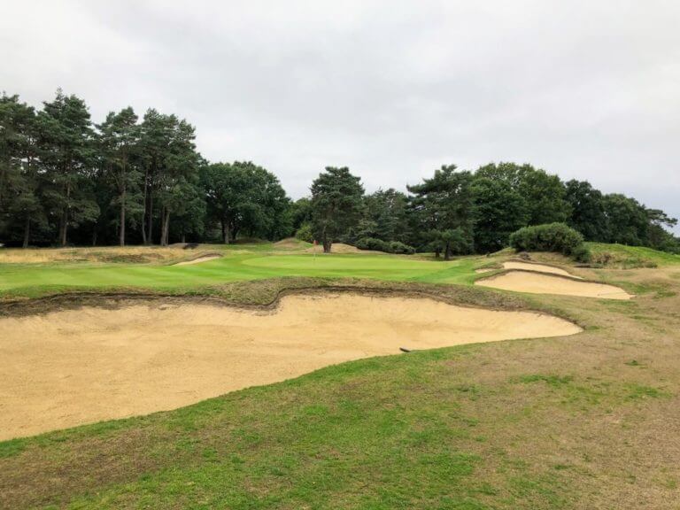 Large sand bunkers flank a narrow green on the new course