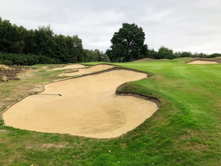 Large sand traps block an approach to the green on the new course