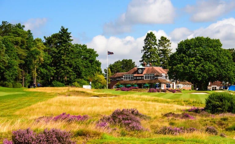 A flag stands next to the Sunningdale Golf Clubhouse