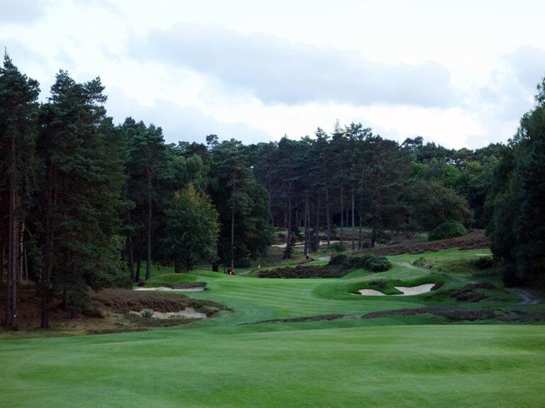 A downhill seventh hole is flanked by bunkers and woodland