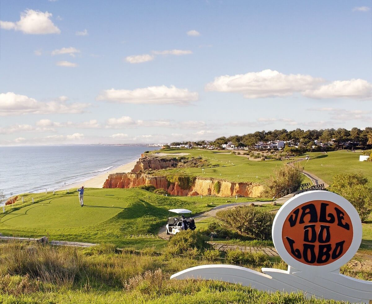 A golfer tees off on the signature sixteenth hole of the Royal Course