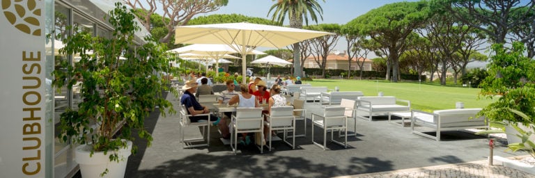 Golfers enjoy lunch at the clubhouse overlooking the practice putting green