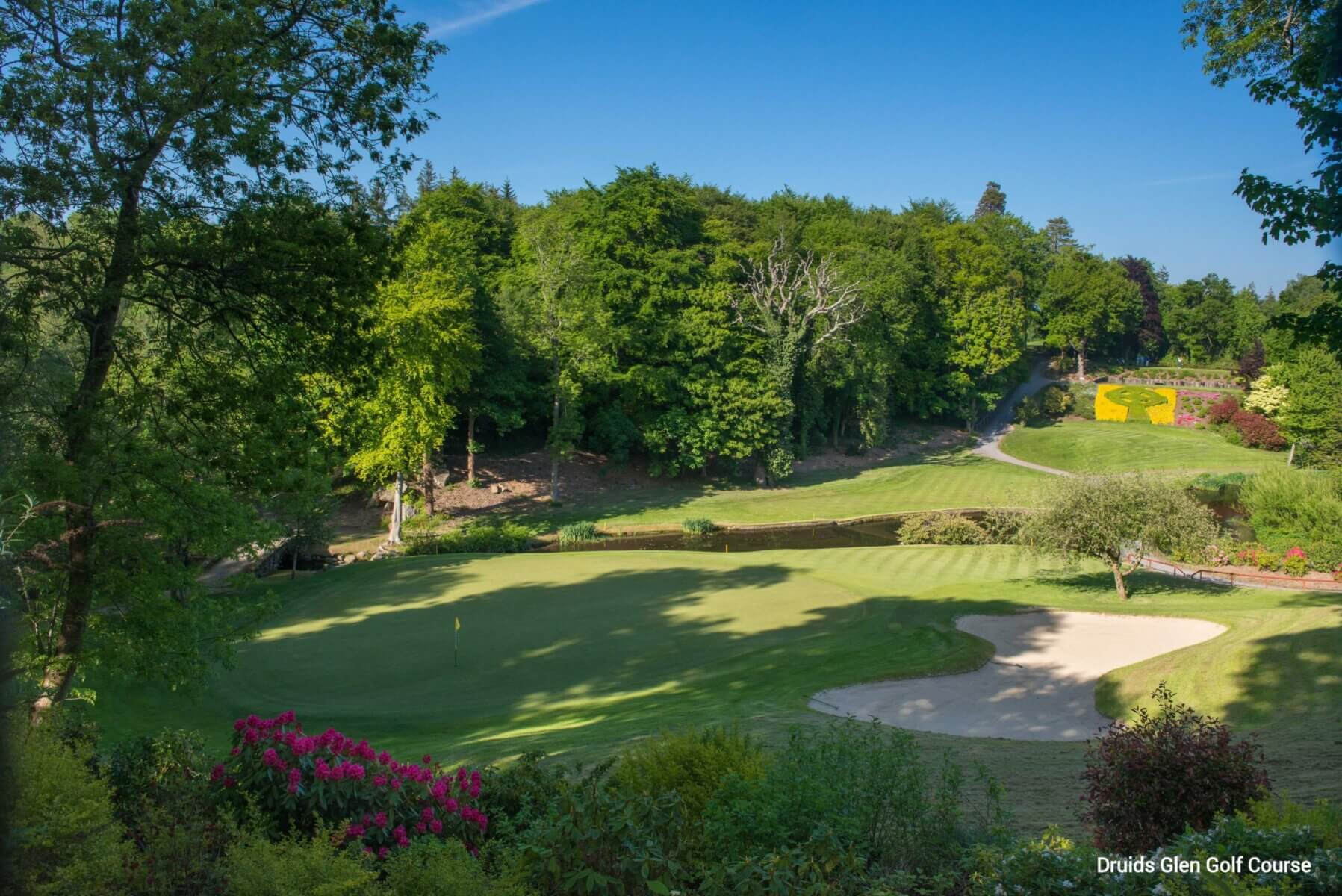 A green is protected by a moat and bunker at Druids Glen