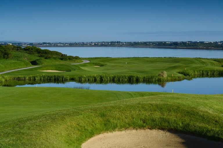 A body of water separates the twelfth fairway from green at Galway Bay Golf Resort